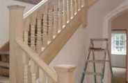 Finished staircase with soft wood spindles and handrail