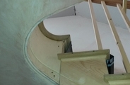 Flexible ply curved staircase string